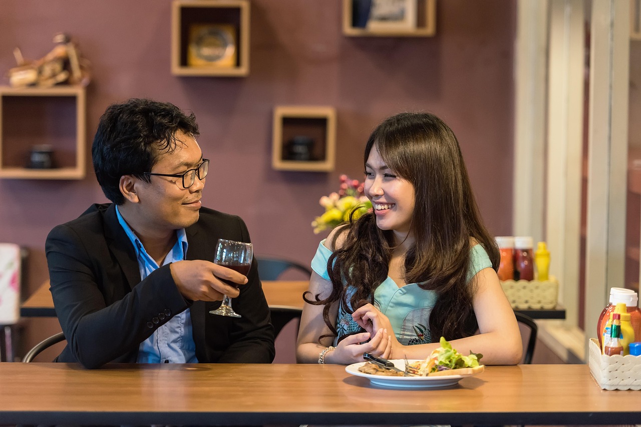 Two people sitting across a table from each other, talking